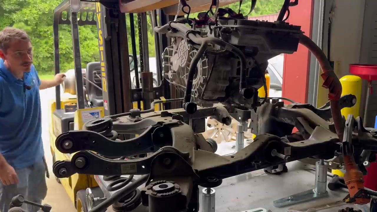 Hyster forklift with straps lifting the old IONIQ 5 rear drive unit off the subframe