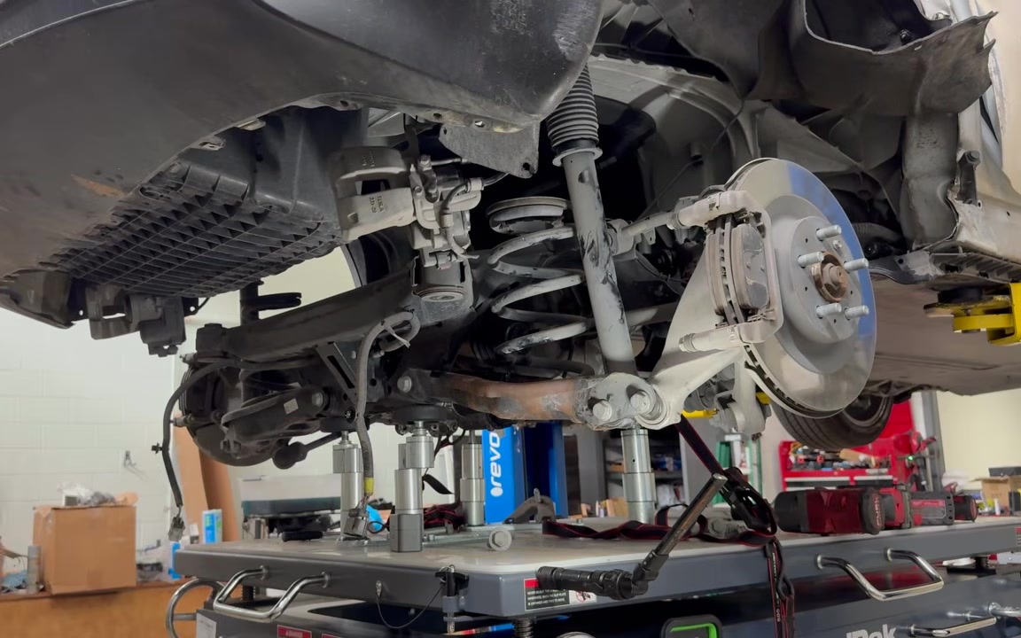Model Y rear subframe and drive unit coming down on a BendPak lift table